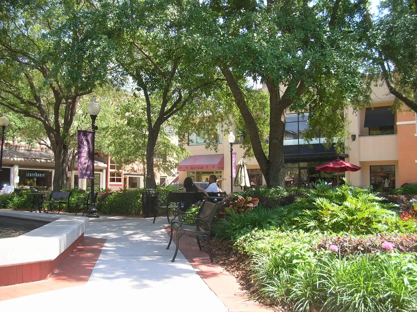 Shaded walkways and shopfronts around the fountain at Hyde Park Village in South Tampa.