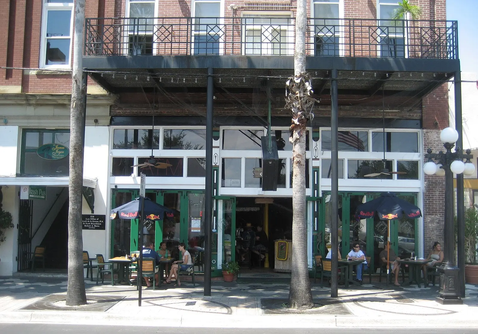 Sidewalk tables under umbrellas outside a restaurant on Seventh Avenue in Ybor City, Tampa.