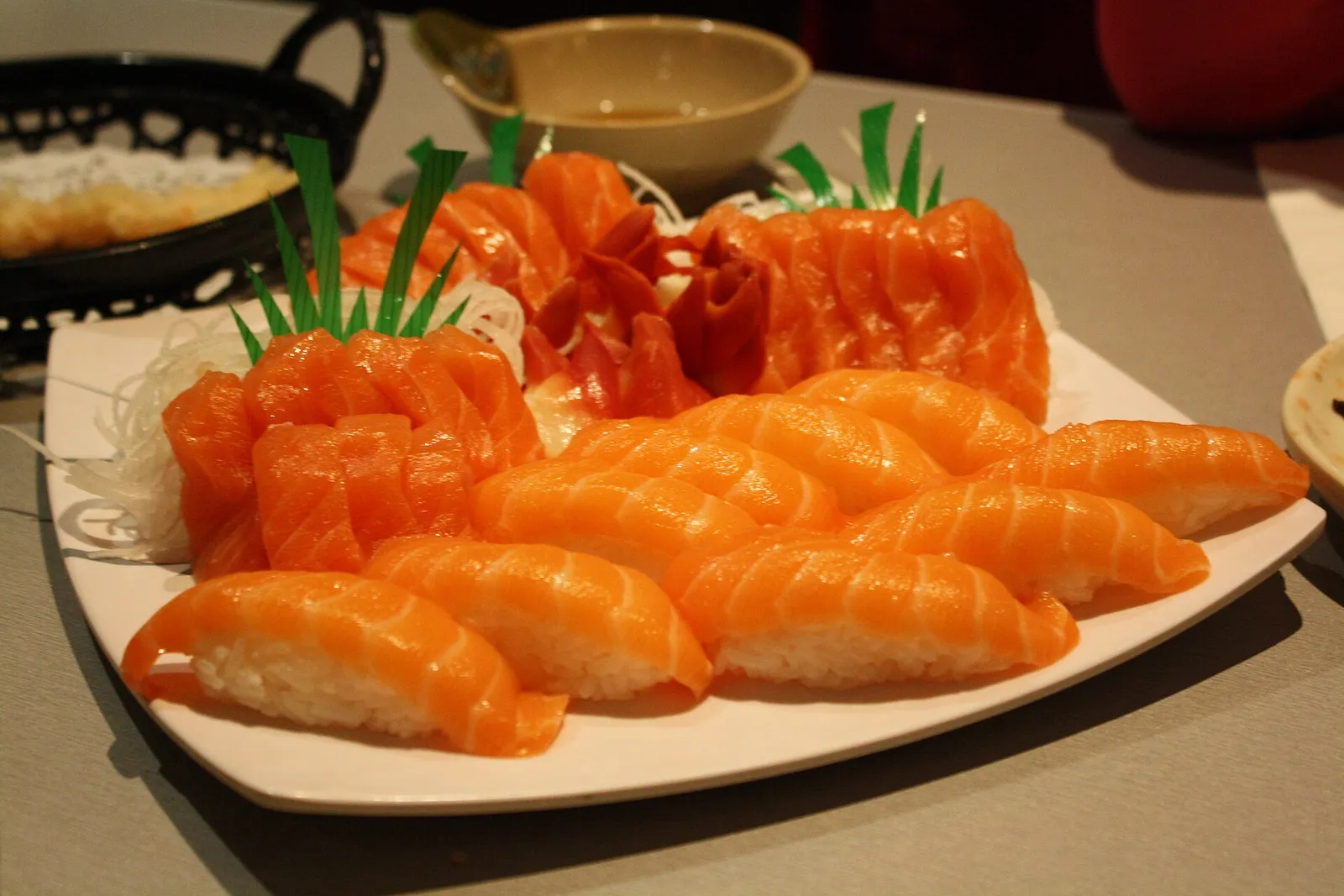 Salmon nigiri and sashimi on a white platter. The photo was not taken at a Tampa restaurant.