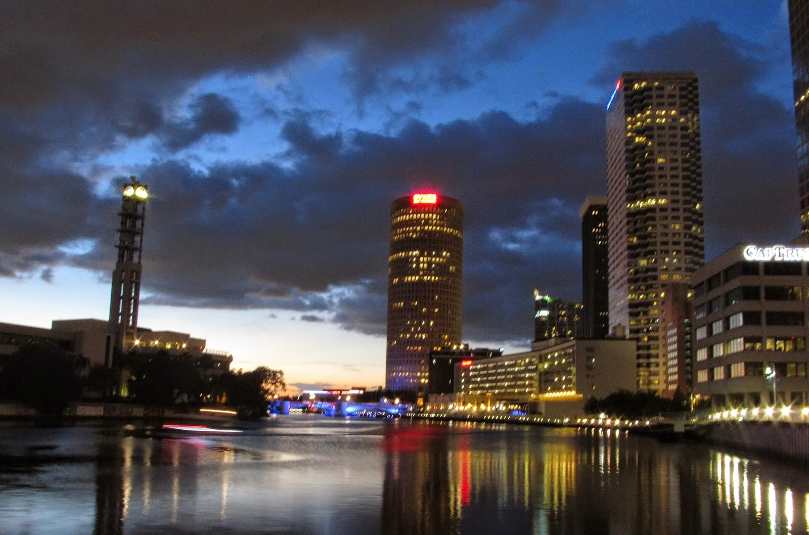 The Hillsborough River and the Tampa Riverwalk at dusk in downtown Tampa.