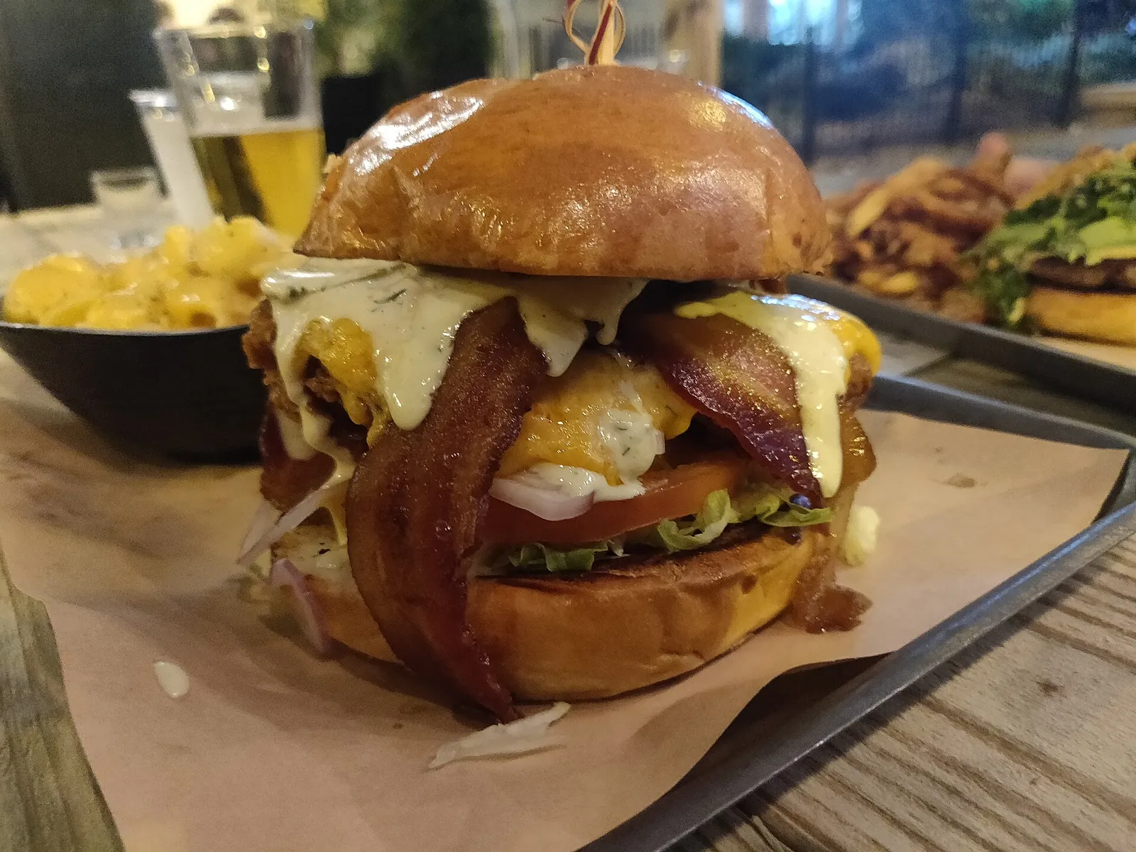 A bacon cheeseburger on a brioche bun with macaroni and cheese on the side. The photo was not taken at a Tampa restaurant.